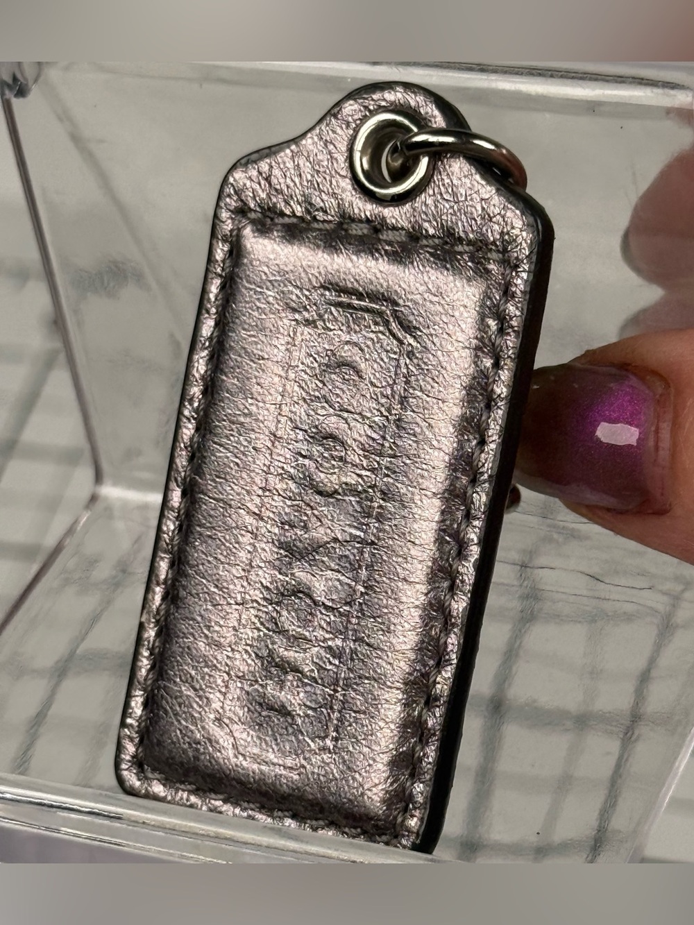 Coach Bronze Embossed Metallic Leather Key. Hang tag 2.5 by 1.25 inch.